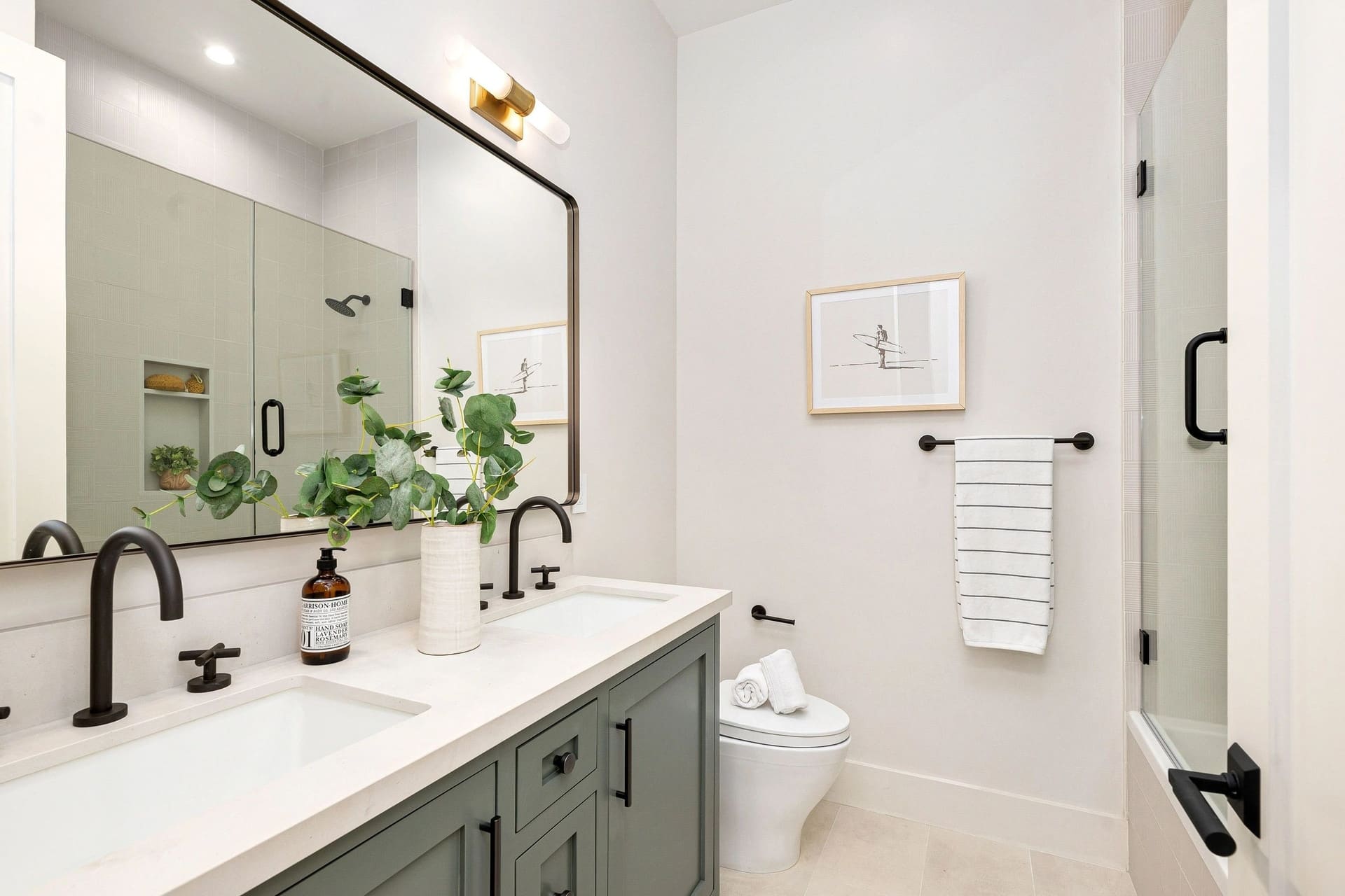 A remodeled bathroom with a double vanity
