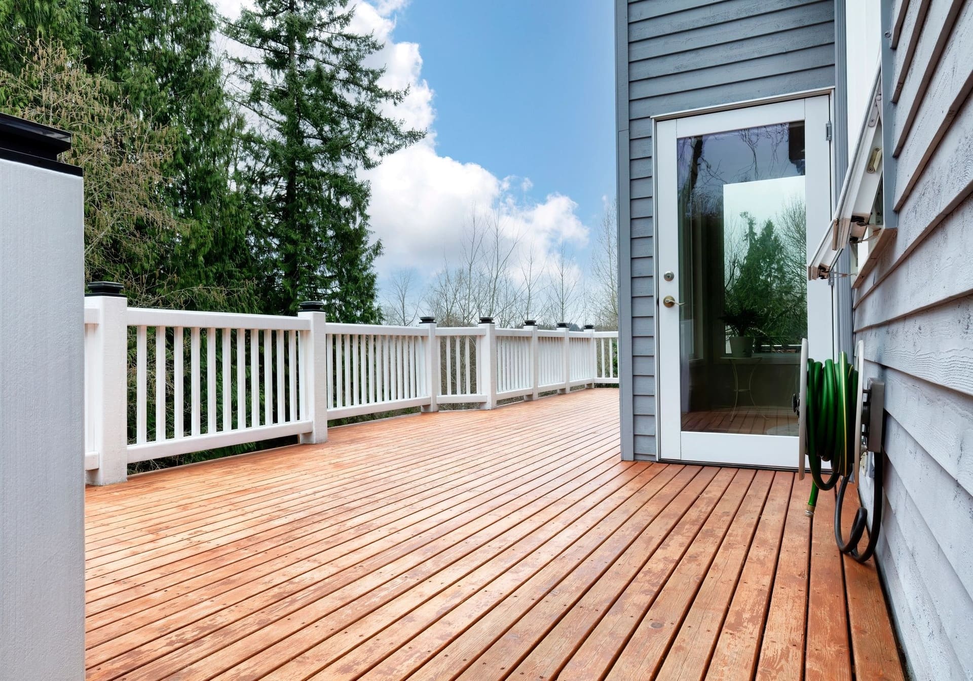 A new wooden deck with a white railing