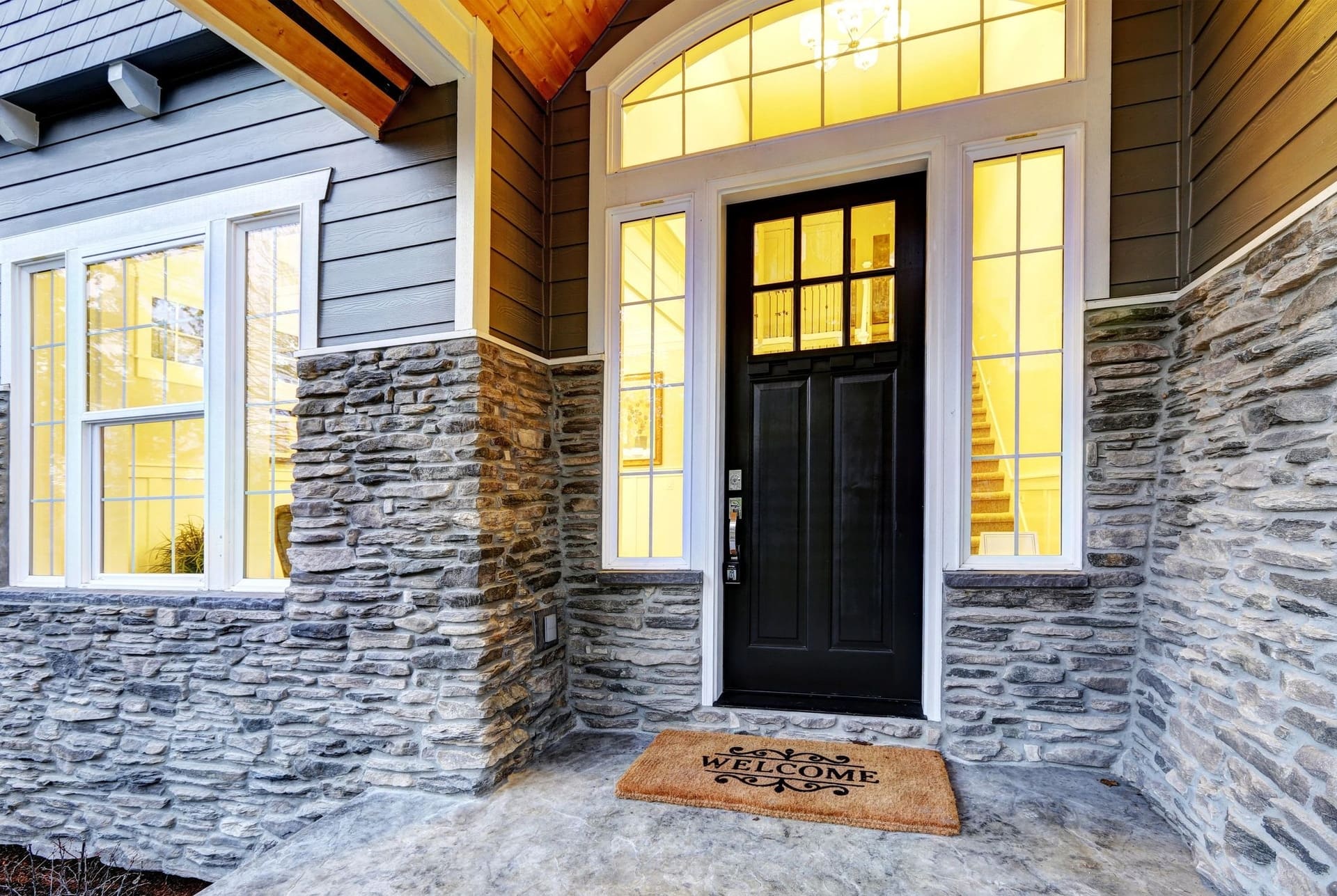 A new front entry door with sidelights and transom windows