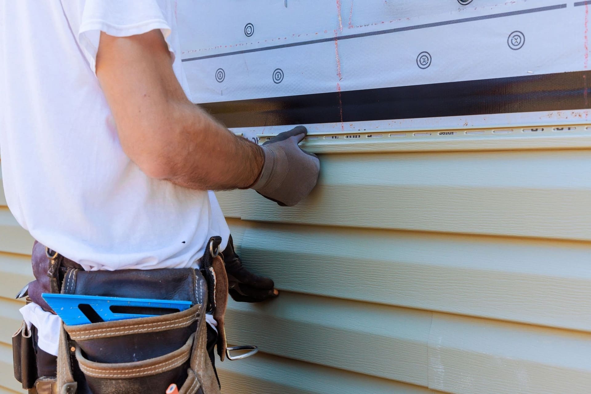 Vinyl siding being installed on a house